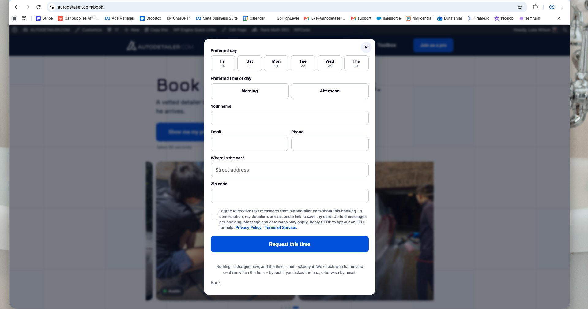 autodetailer.com/book booking form, bottom of the request form showing the unticked SMS consent checkbox directly above the Request this time button